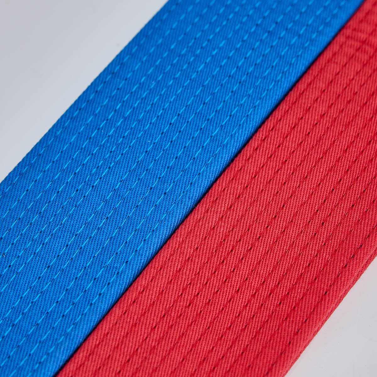 Woven martial arts belt webbing, blue and red close-up texture