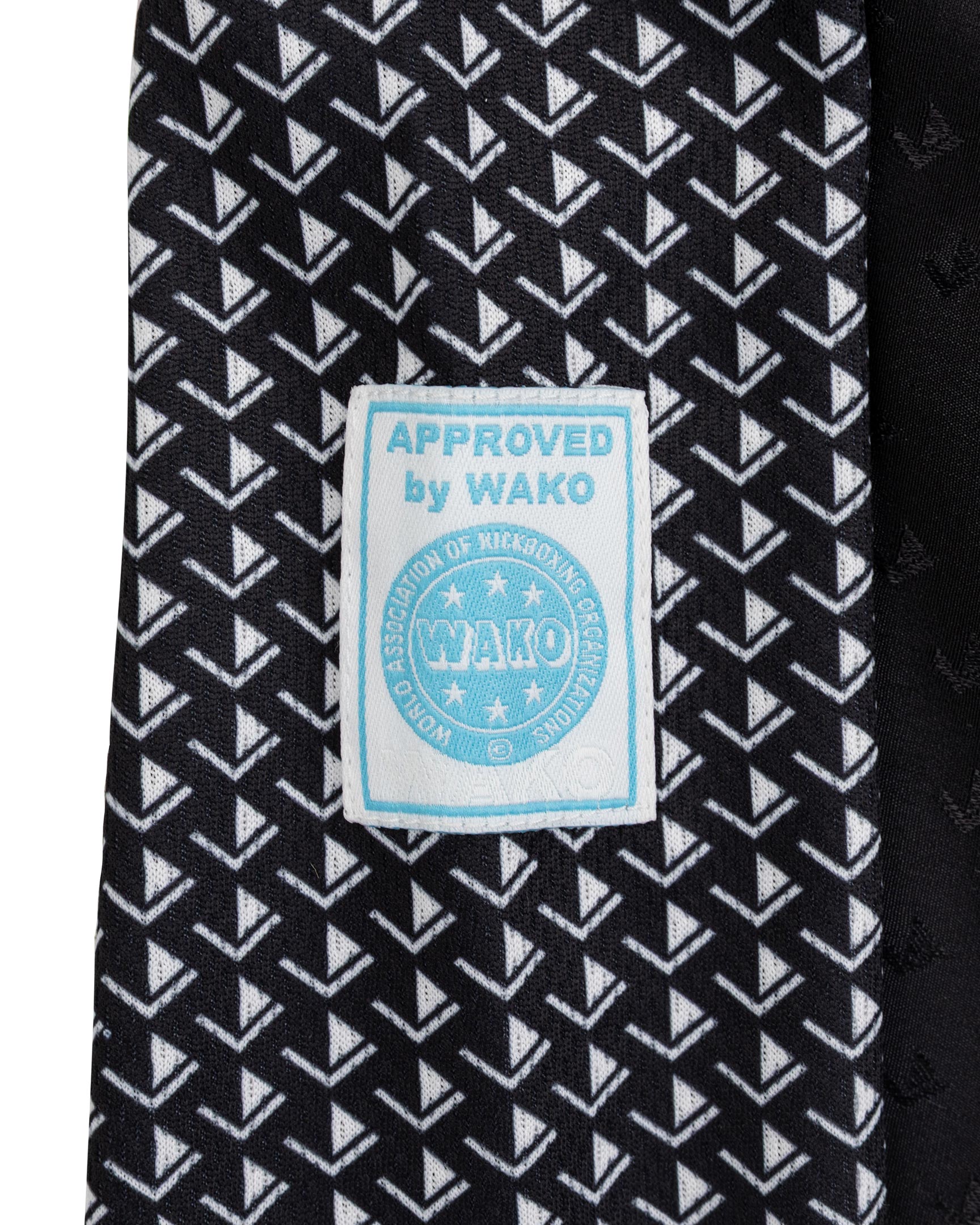 Tenacity pant by WAKO C-Gear, black fabric with patterned logo patch on inner leg