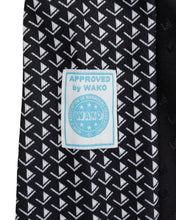Tenacity pant by WAKO C-Gear, black fabric with patterned logo patch on inner leg