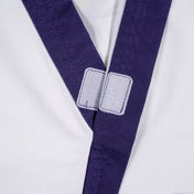 Martial arts gi collar close-up with purple trim and hook-and-loop fastener