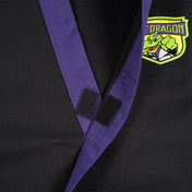 Black martial arts gi collar detail with purple trim and dragon emblem patch