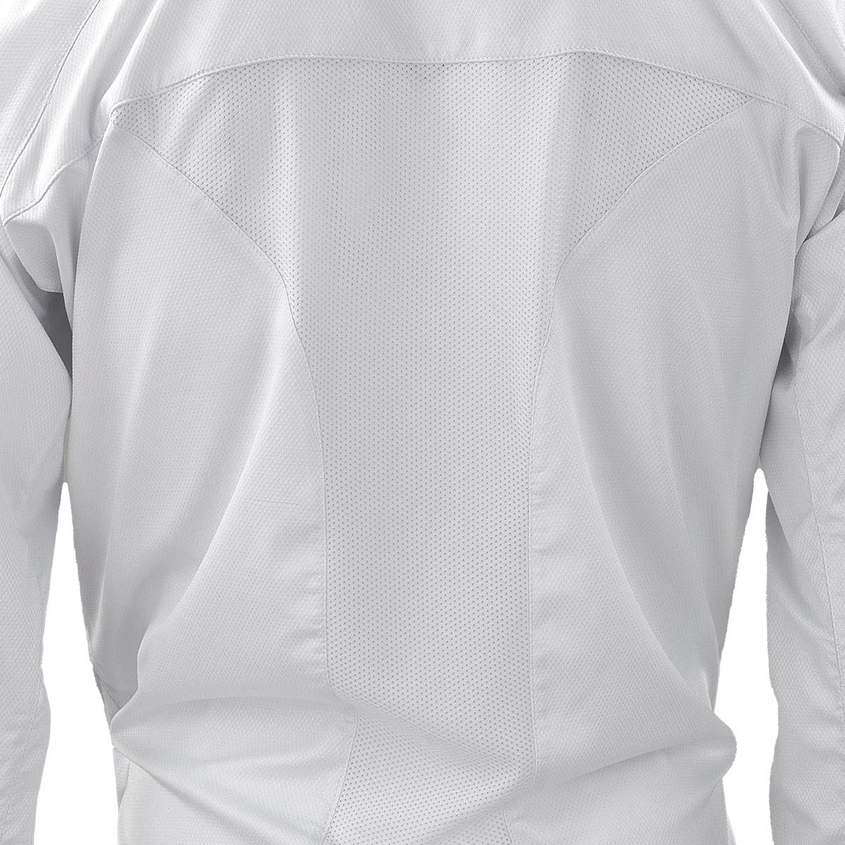 White karate gi jacket close-up showing textured fabric and stitched panel seams.