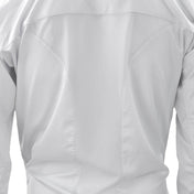 White karate gi jacket close-up showing textured fabric and stitched panel seams.