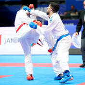 White karate gi set on two athletes with red and blue belts during sparring.