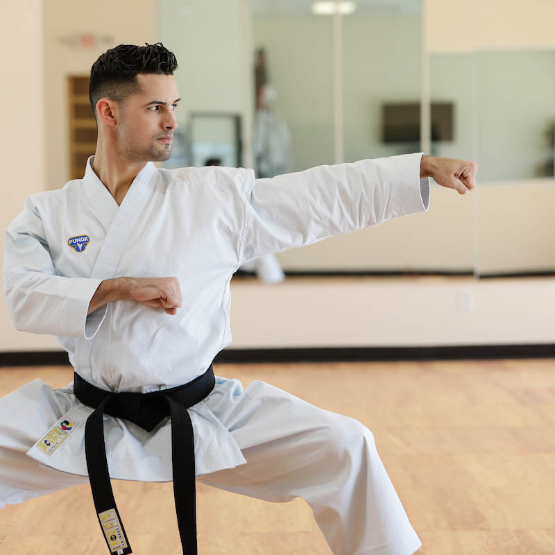 Punok kata uniform gi with white jacket, black belt, and logo patch