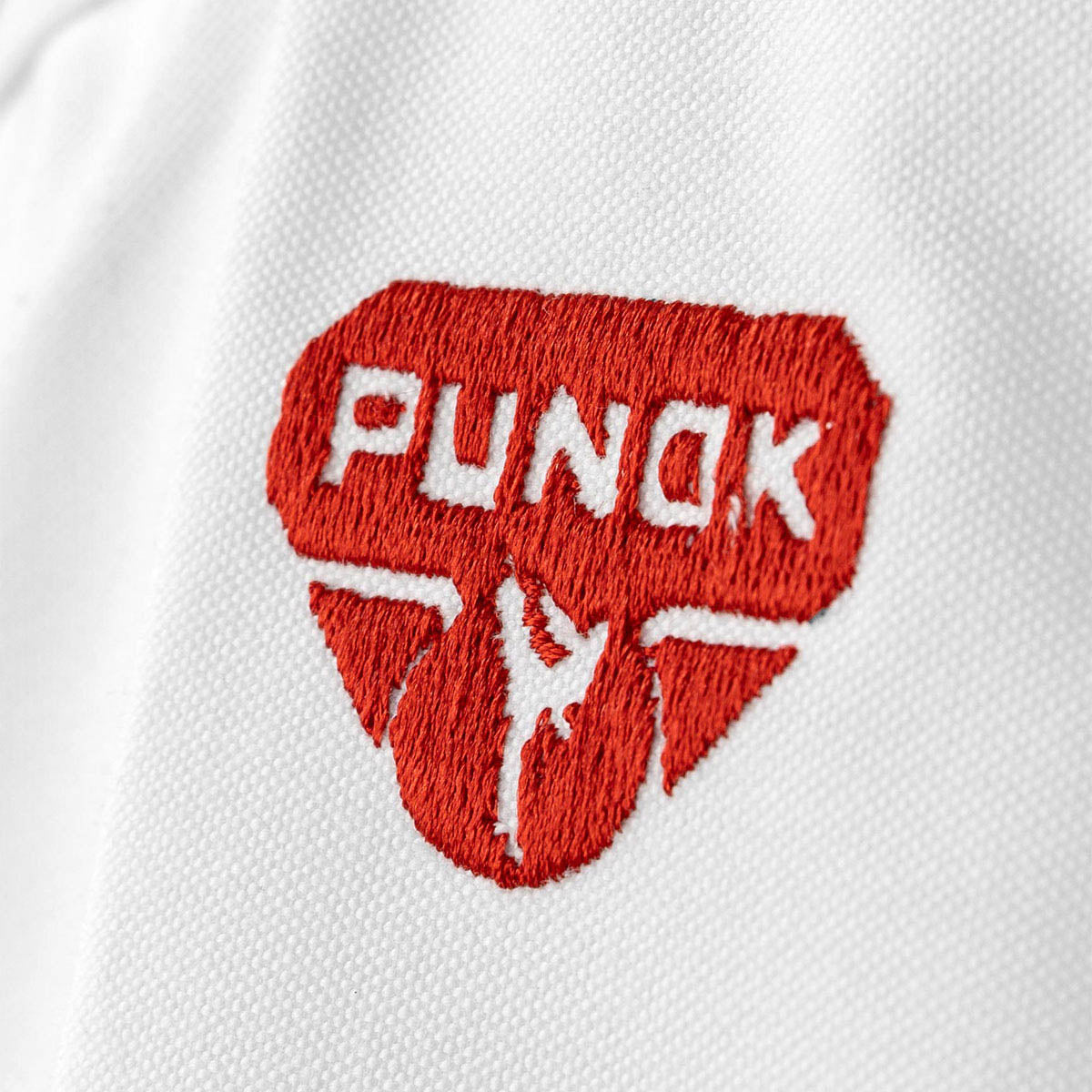 Embroidered Punok logo patch in red on white gi fabric