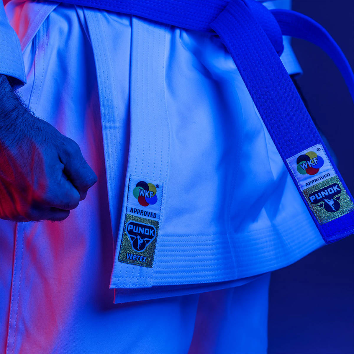 White kata gi jacket with blue belt and approval patch labels