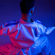 Martial arts gi jacket with small chest emblem, worn with belt and pants