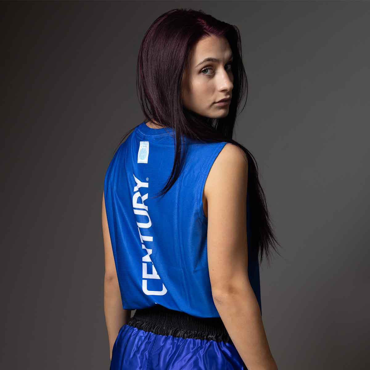 Blue sleeveless tee with white vertical logo print on the back