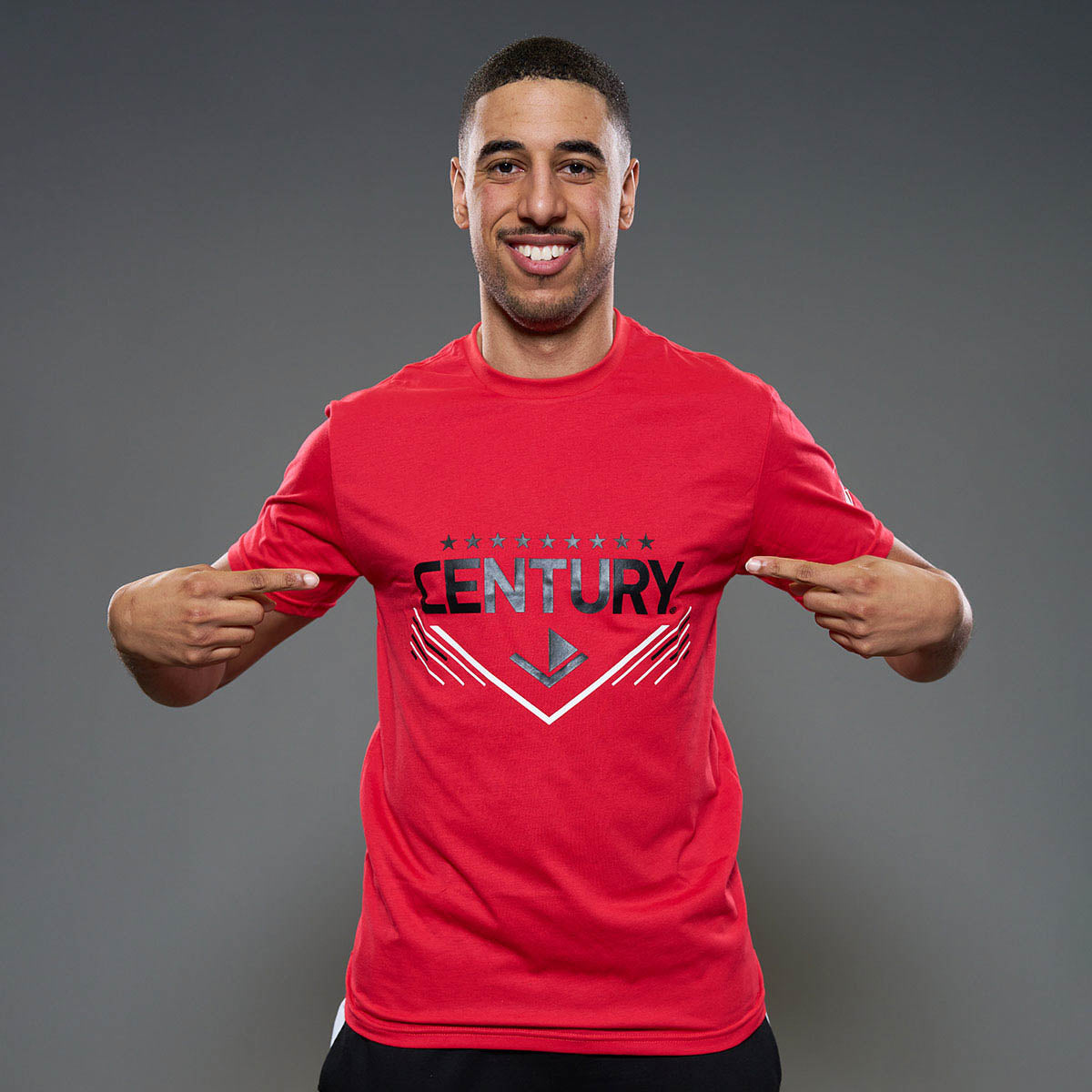 Red unisex t-shirt with front CENTURY logo graphic, model wearing it