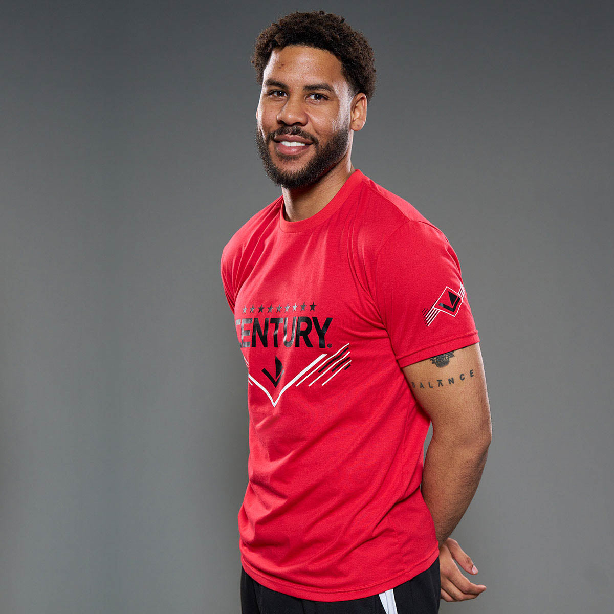 Red unisex t-shirt with front graphic and small sleeve logo, side view