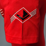 Red unisex t-shirt front chest logo graphic and stitched hem, close-up