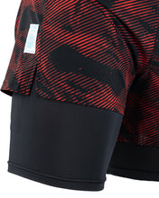 Men's red patterned training shorts with blue/black inner lining visible at the side hem.