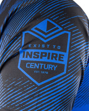 Blue patterned sleeve detail with Exist to Inspire Century emblem on athletic tee