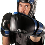Black boxing gloves with blue accents and Century logo, worn in a fighting stance