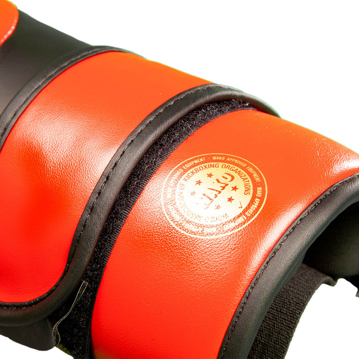 C-Gear boxing gloves close-up, orange-red palm panel with circular logo and black trim