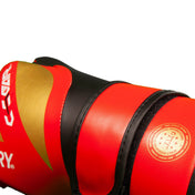 Close-up of red and black boxing glove with textured surface and stitched seams.