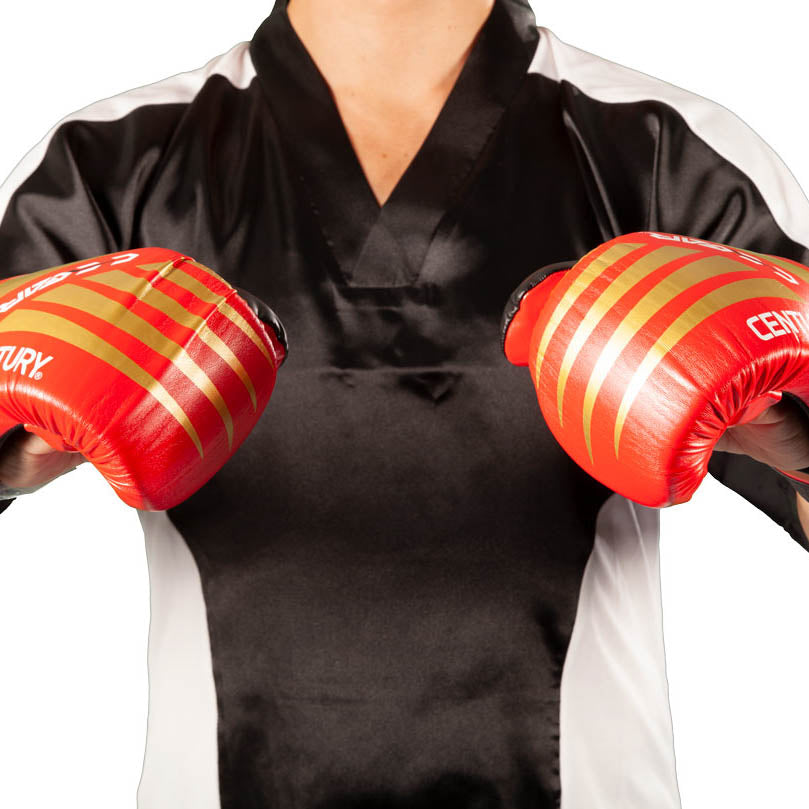 Red-and-black padded boxing gloves with bold stripe design on the knuckles.