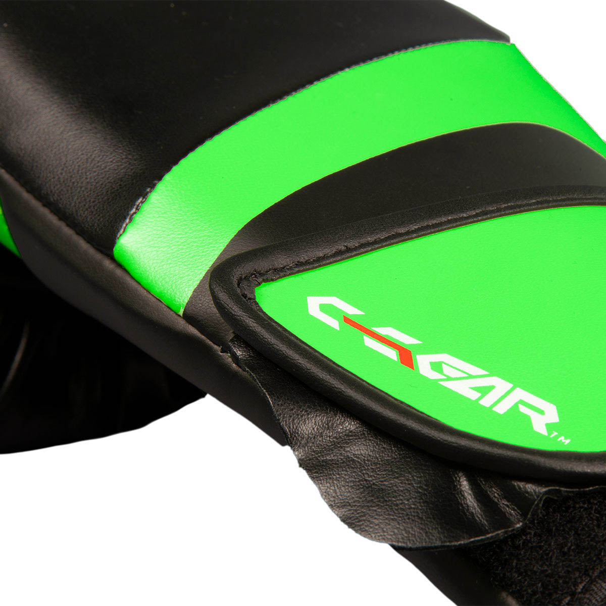 Close-up of neon green and black kickboxing glove with C-Gear branding on the pad.
