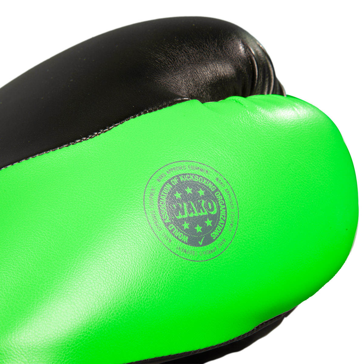 Close-up of a neon green kickboxing glove back with a round training stamp.