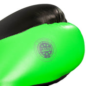 Close-up of a neon green kickboxing glove back with a round training stamp.