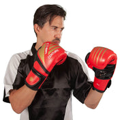 Red and black kickboxing gloves worn on hands, Century logo