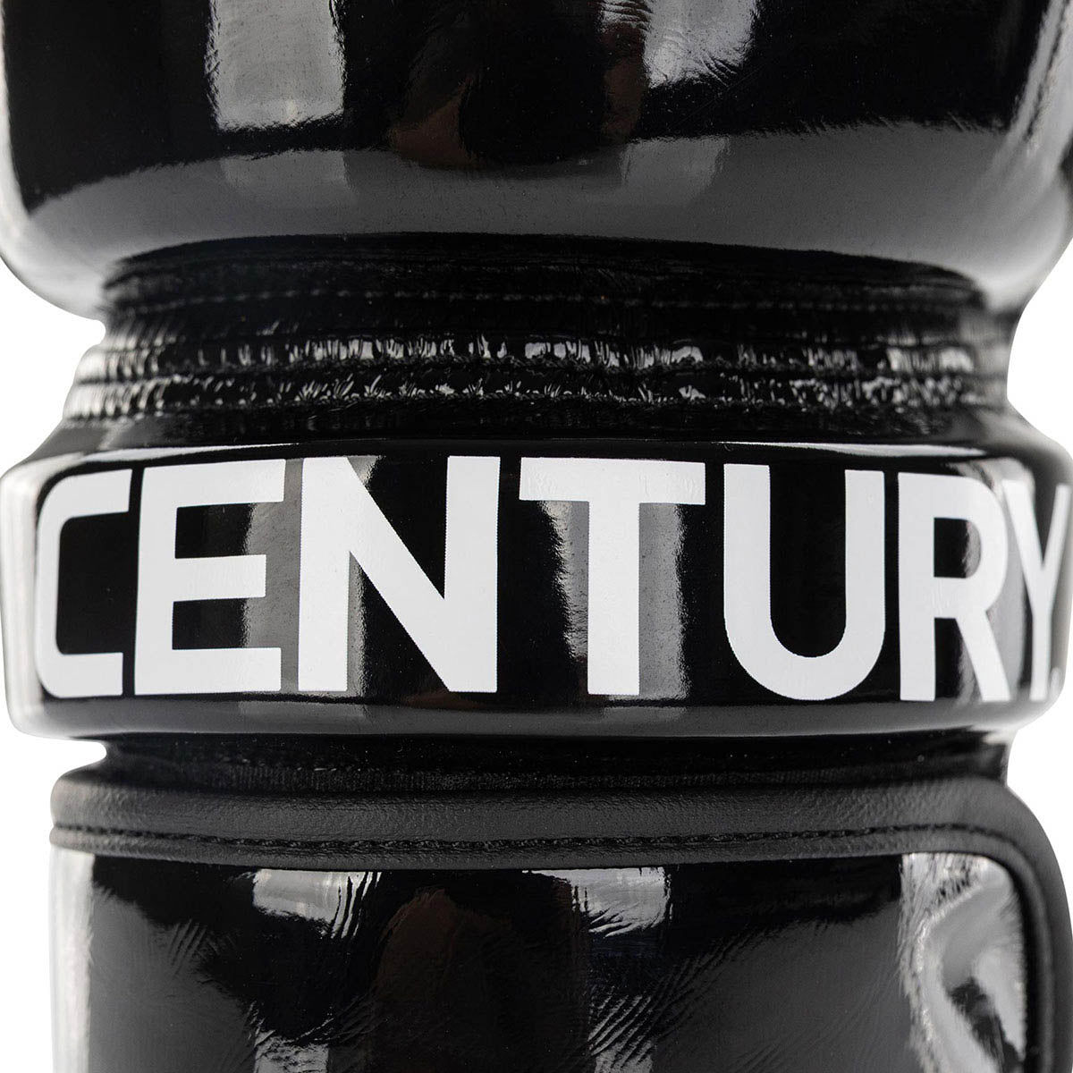 Black boxing glove close-up showing bold 'CENTURY' branding on the wrist band