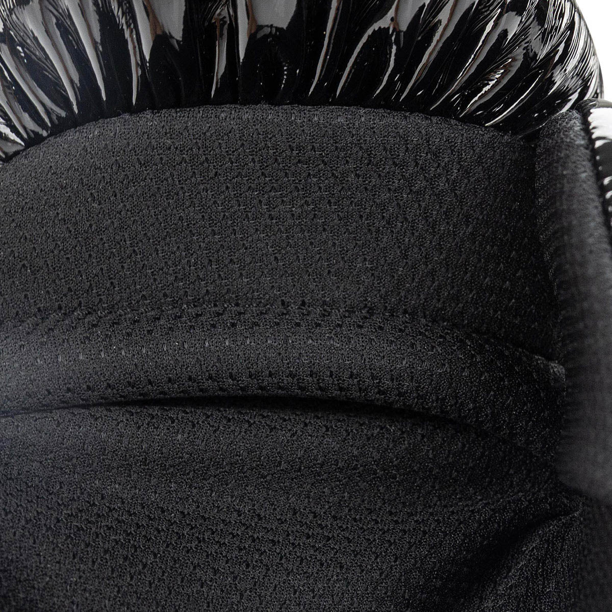 Black boxing glove padded palm cushion close-up with textured surface.