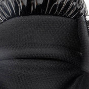 Black boxing glove padded palm cushion close-up with textured surface.