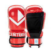 Pair of red boxing gloves with a white geometric logo and black wrist strap