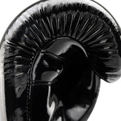 Black Valor kickboxing glove close-up with glossy shell and curved knuckle padding