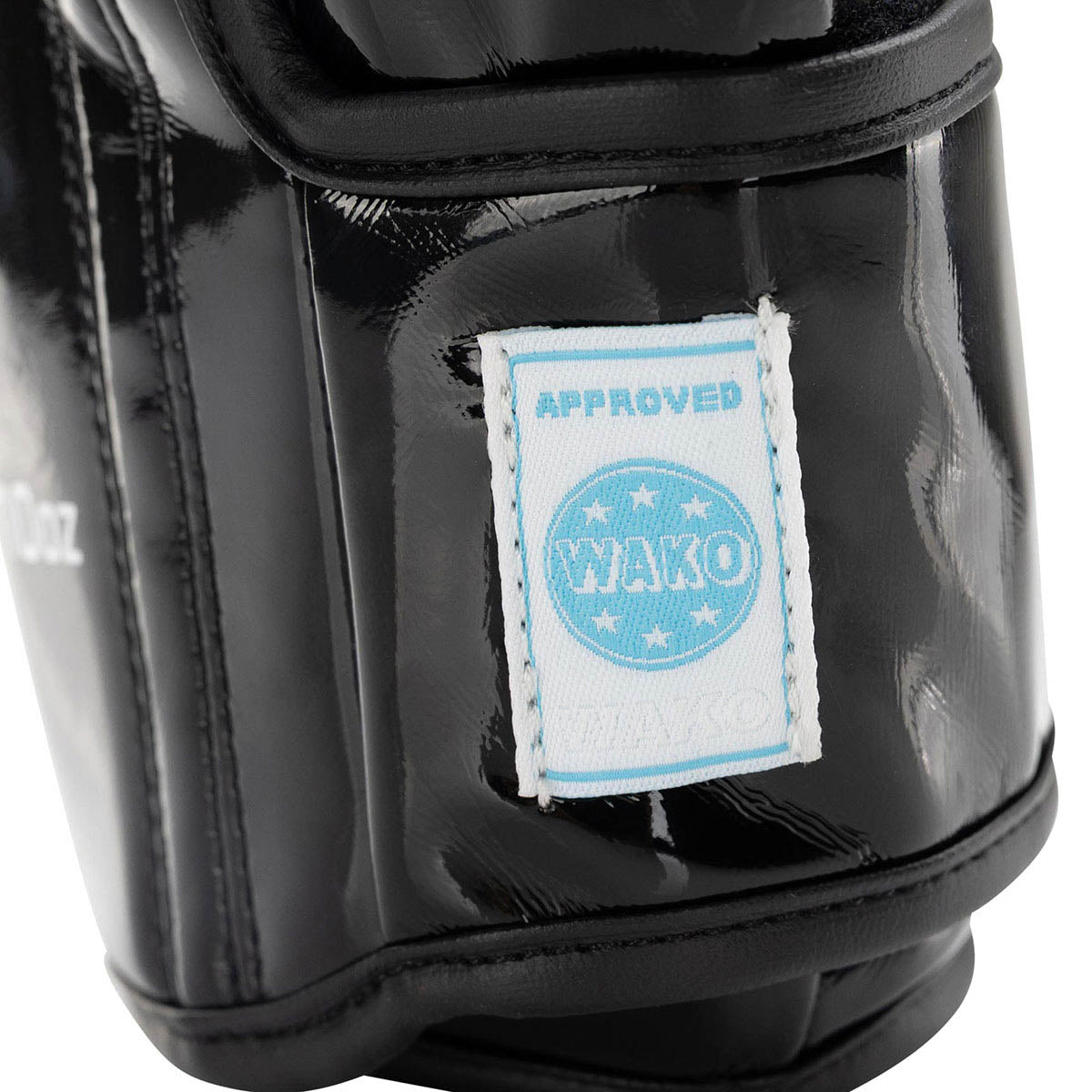 Black Valor kickboxing glove close-up with Approved WAko label on wrist