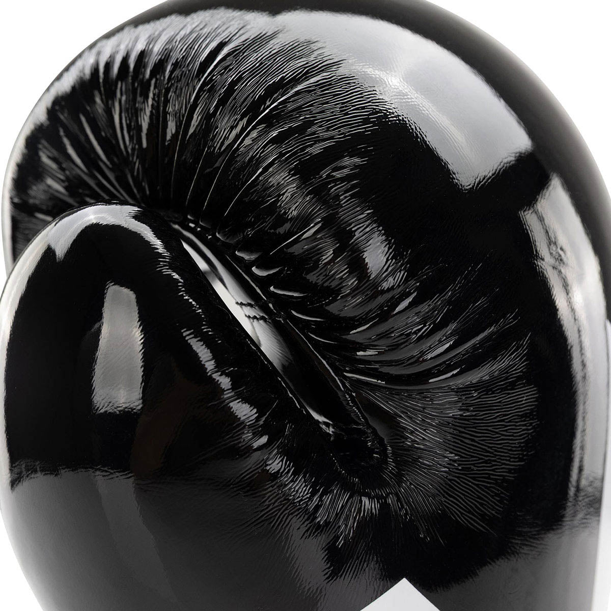 Black Valor kickboxing glove close-up of glossy knuckle area with seam details