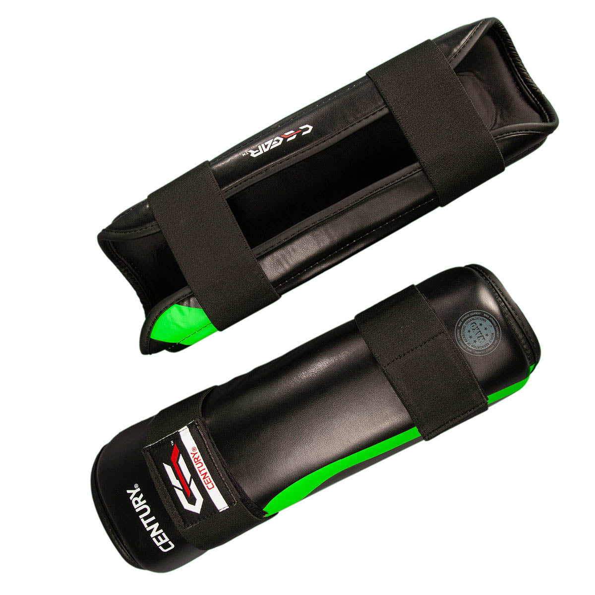 Black shin guards with green stripe and front strap closure; interior lining visible.