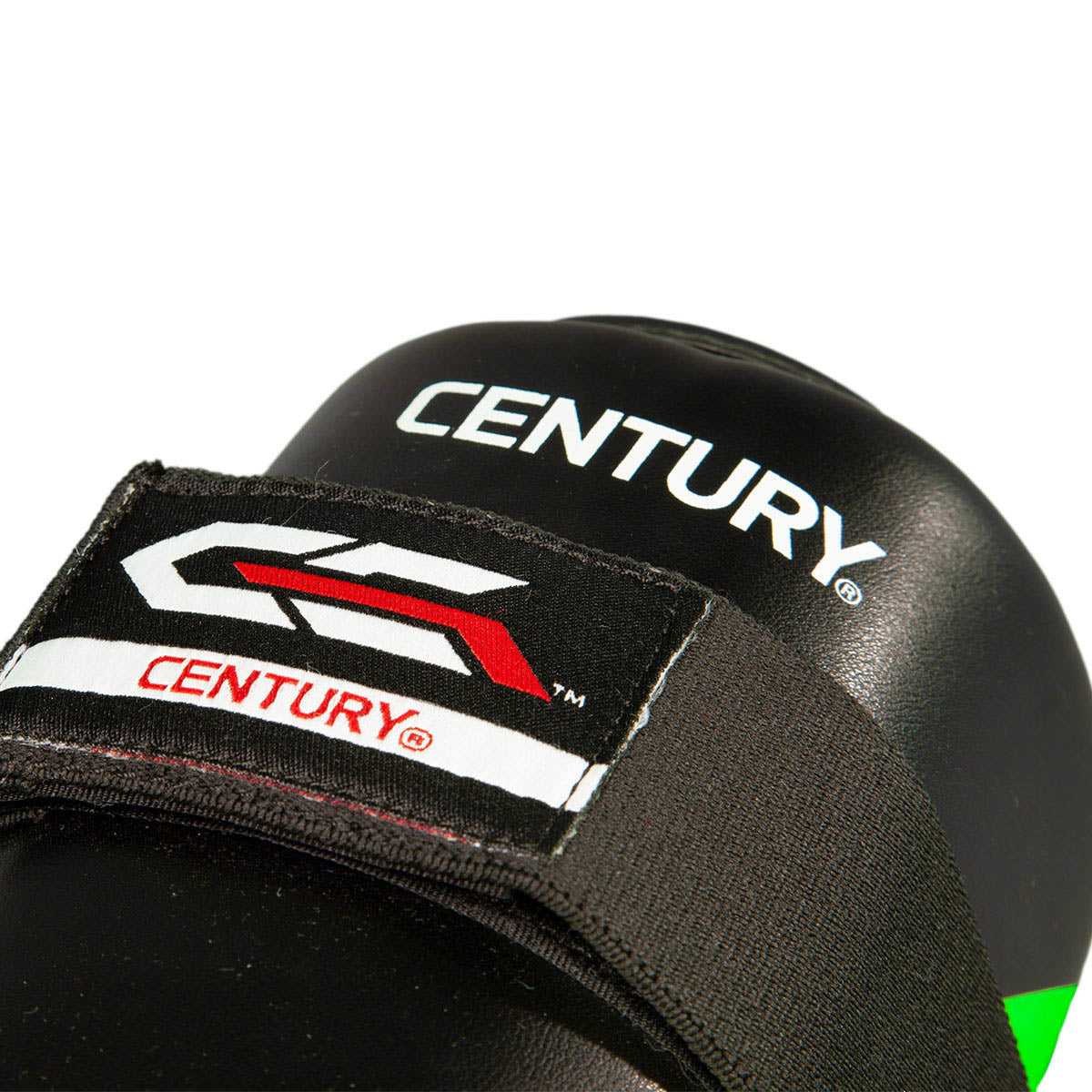 Close-up of black shin guard with Century branding patch and red/white logo graphic.
