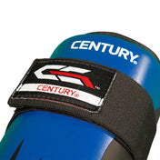 Blue boxing shin guard close-up with Century logo patch and strap