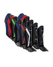 Shin instep guards set with black curved shells and multicolor geometric accents