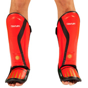 Red shin and instep guards worn, Century logo on front and black securing straps