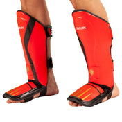 Red and black shin-instep guards with dual straps and padded shin cover