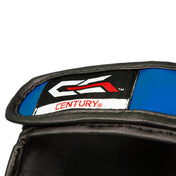 Shin-instep guard close-up with CENTURY logo on blue and black padding