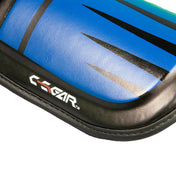 Blue shin-instep guard detail with black edge trim and RAIR logo on pad