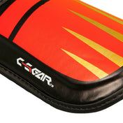 Close-up of red shin guard edge with C-GEAR text and stripe pattern