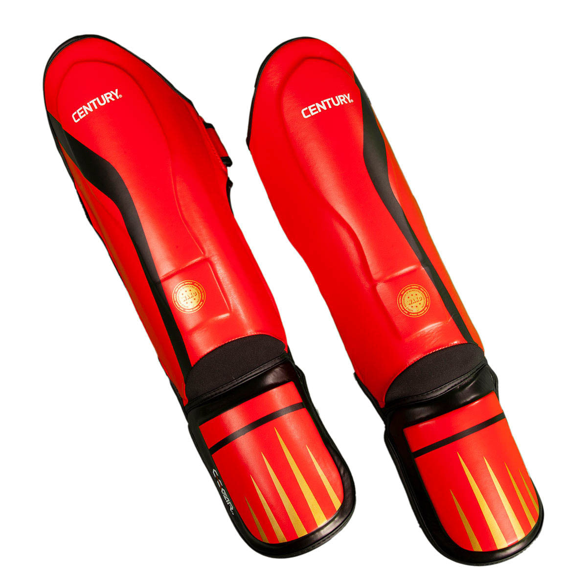 Red shin instep guards with black straps and flame-pattern toe panels; CENTURY logo