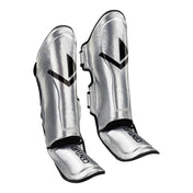 Silver shin guards with glossy finish, V logo panels, and adjustable strap
