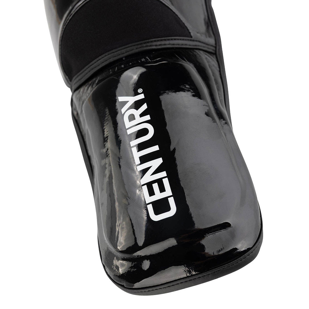 WAKO Valor shin guards, close-up of black glossy shell with vertical “WAKO”