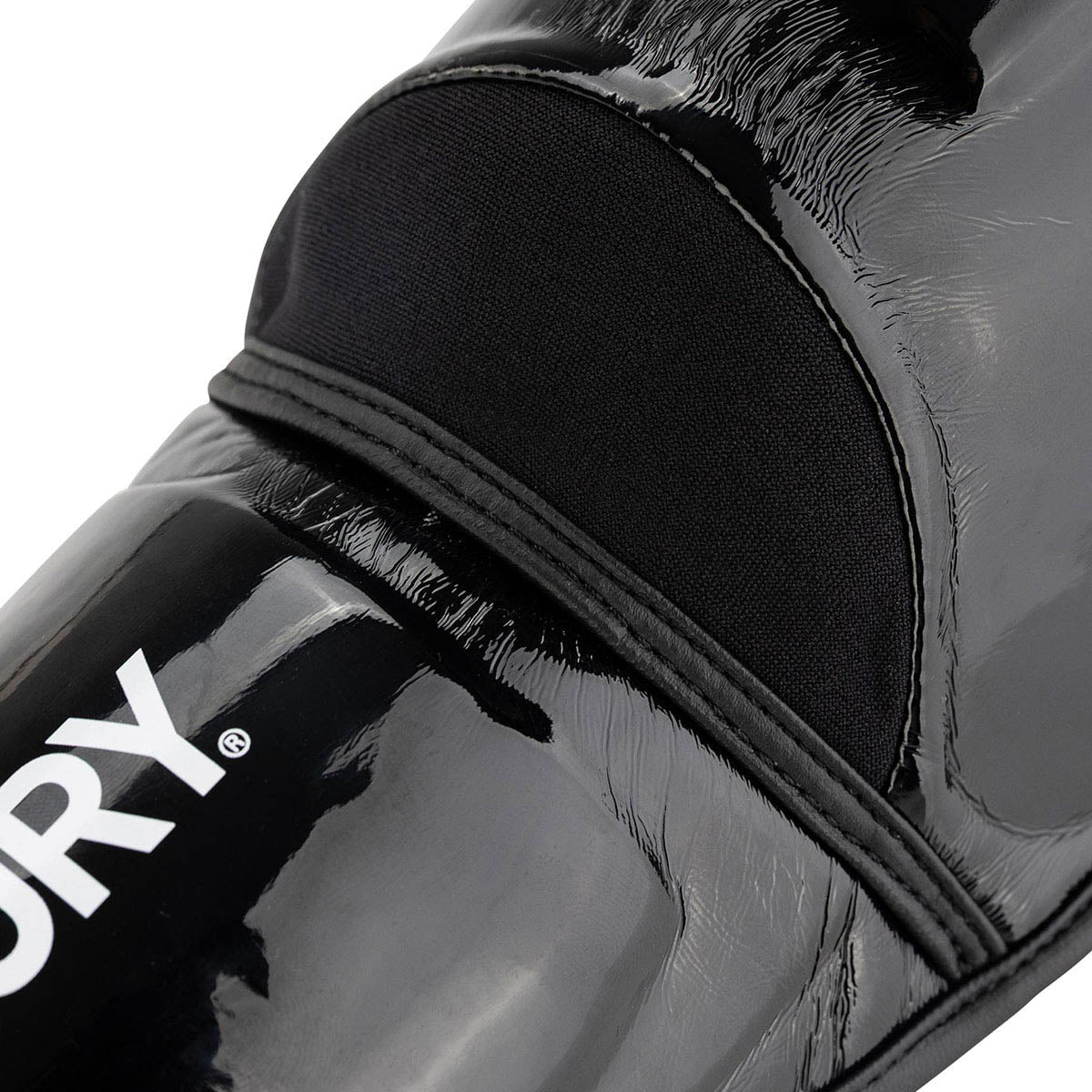 Black glossy shin guards, rounded edges, V logo, hook-and-loop strap detail