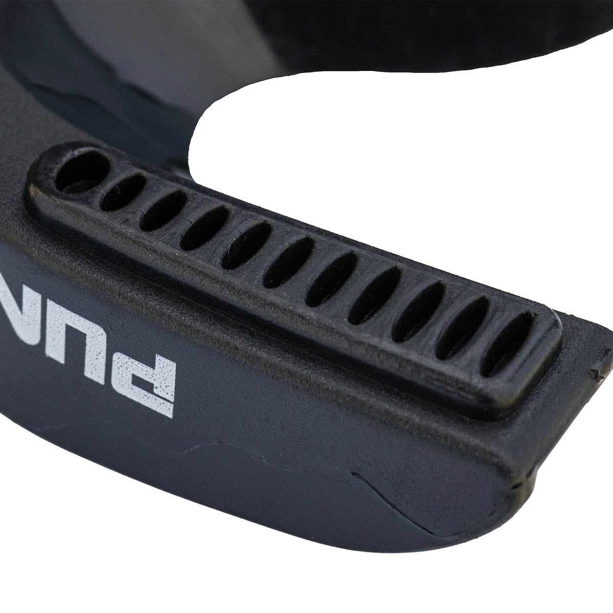 Close-up of black mouthguard with molded edge and ventilation slots