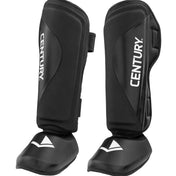 Black shin instep guards with hook-and-loop straps and white logo