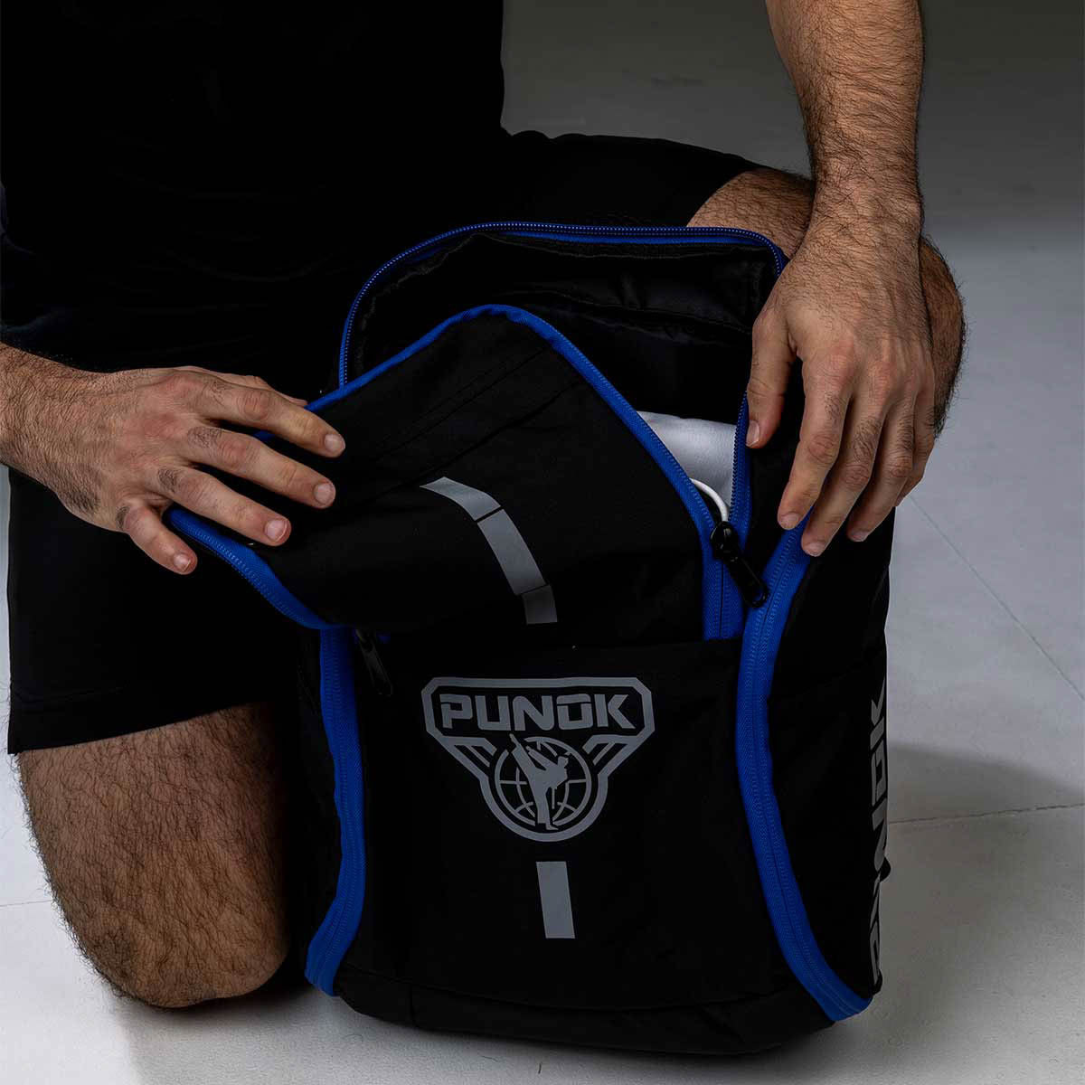 Black backpack with bright blue piping, top handle, and front logo