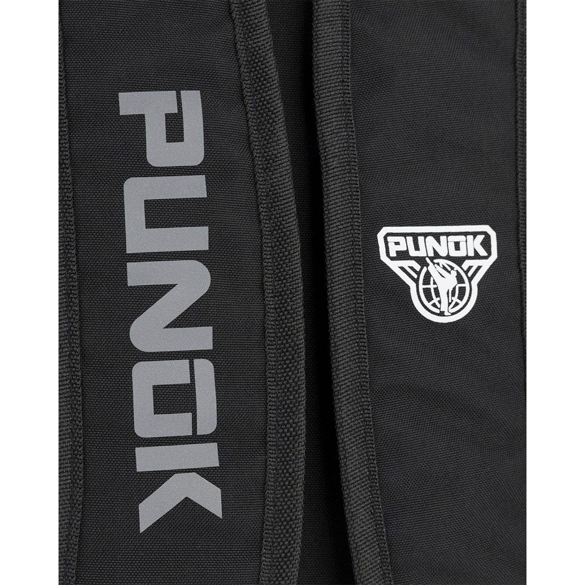 Kumite backpack close-up: vertical PUNOK lettering and round emblem on panel